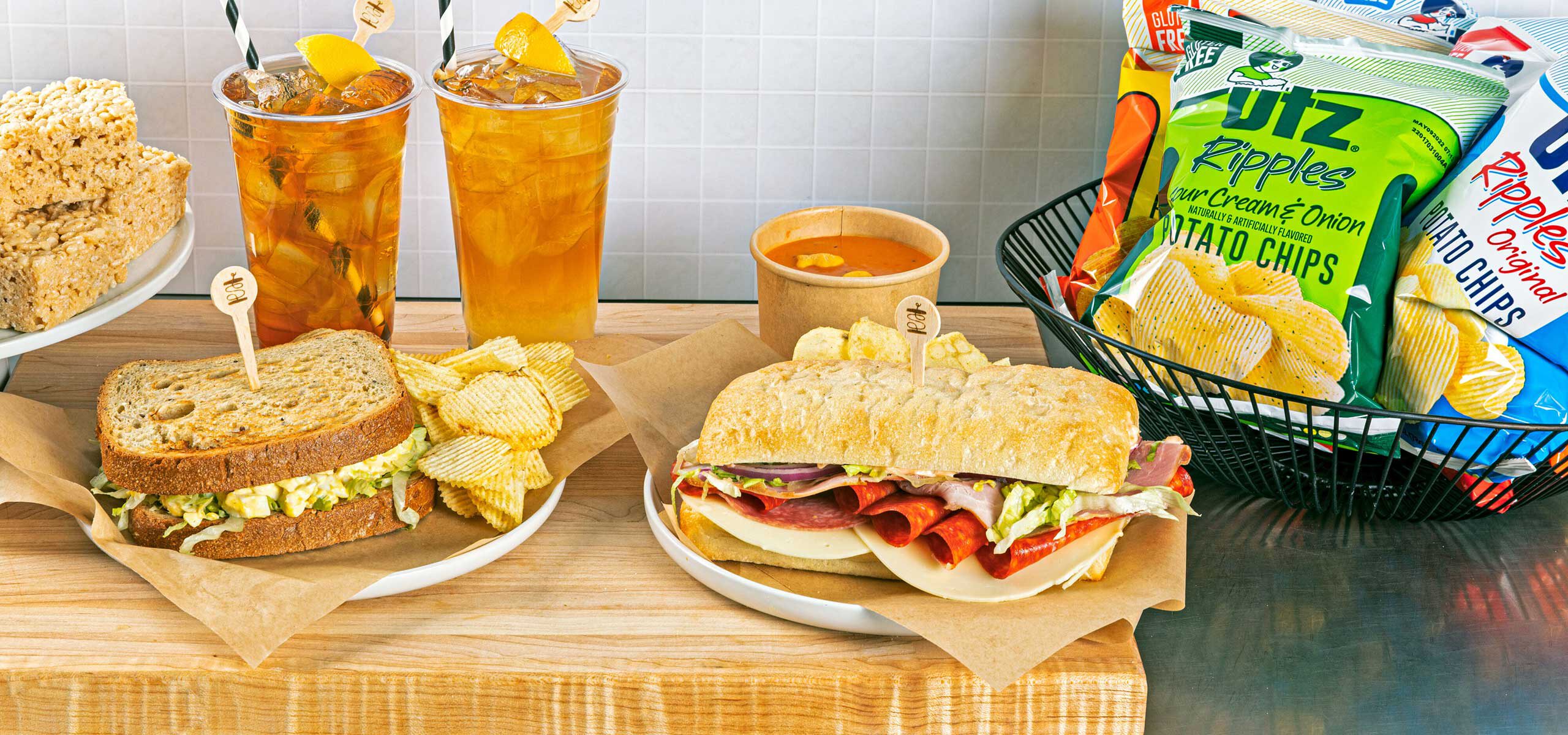 Assorted sandwiches, chips and iced tea