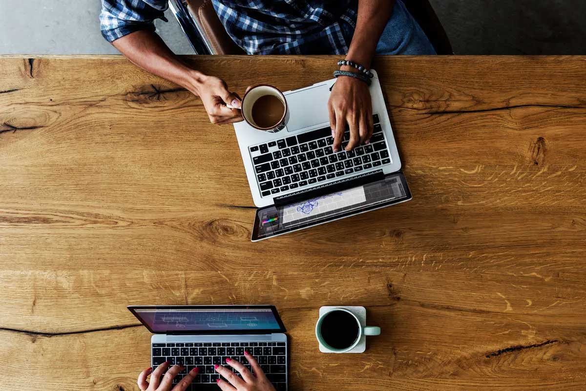 Overhead view of laptops and coffee